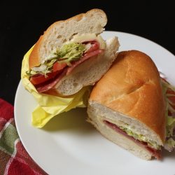italian sub cut in half on plate