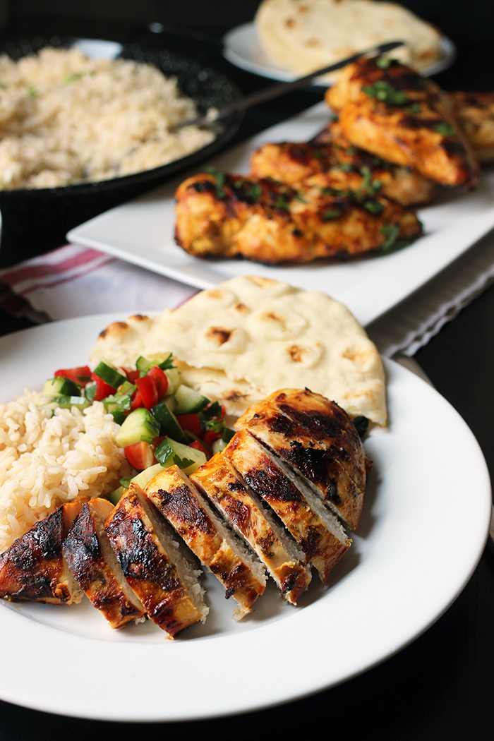 plate of chicken slices with salad rice and naan