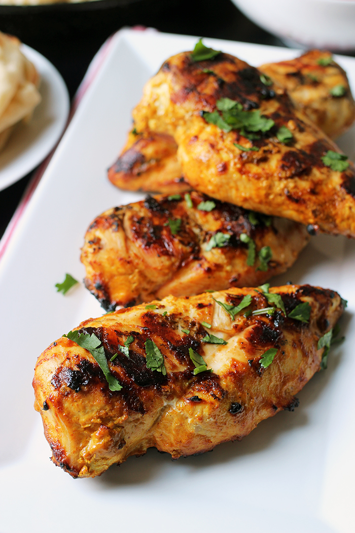 platter of grilled chicken sprinkled with cilantro