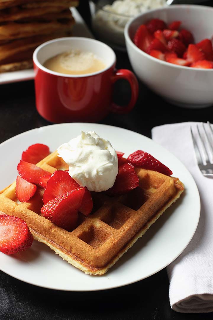 breakfast table with waffles and berries