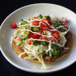 bean tostada on a white plate