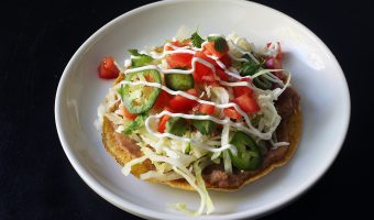 bean tostada on a white plate