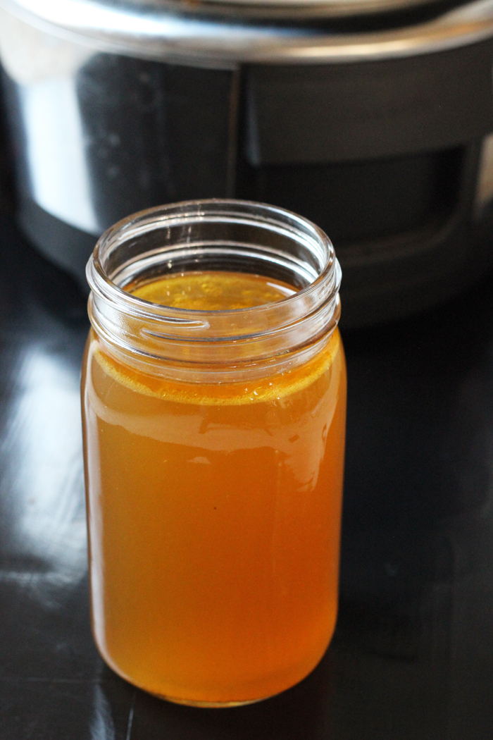jar of chicken stock with slow cooker