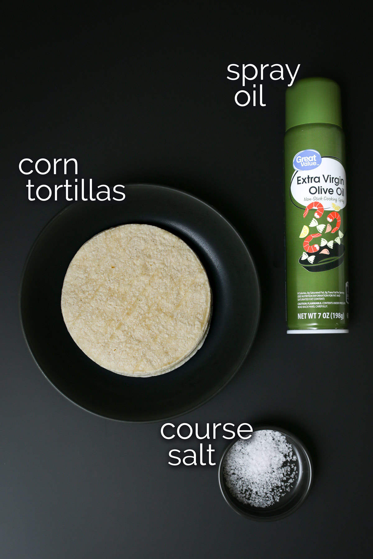 ingredients for air fryer tortilla chips laid out on black table.