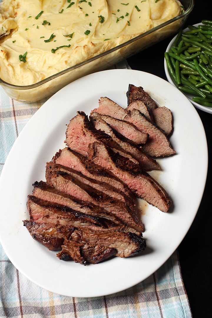 oval white platter with sliced marinated meat