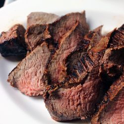 sliced marinated meat on oval platter