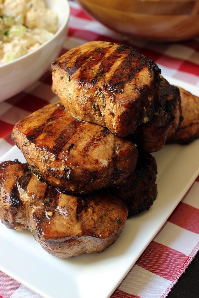 stack of grilled pork chops on rectangle platter