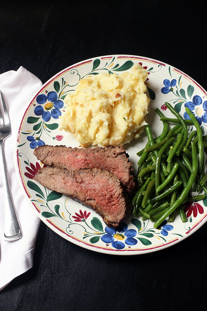 steak dinner on a flowered plate