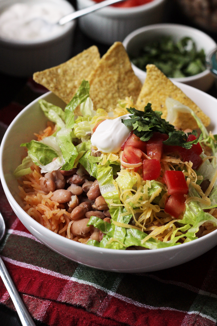 bean and rice bowl with chips and toppings