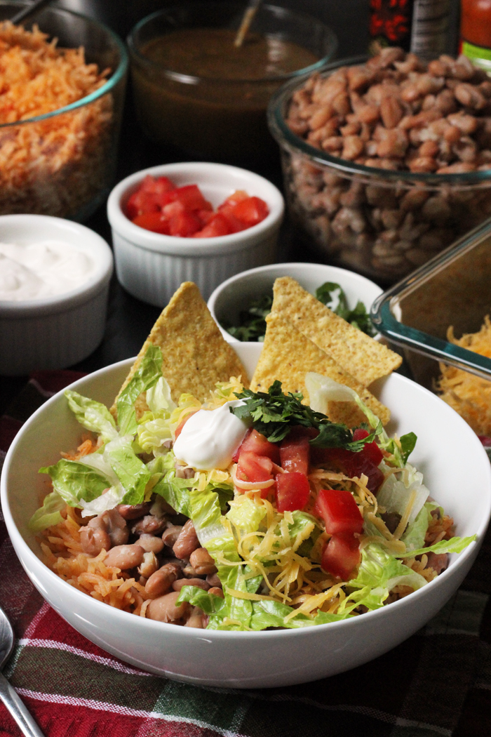 bowl of pinto beans and rice with fixings