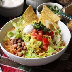 A bowl of rice and beans with toppings