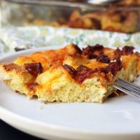 cut slice of egg bake on plate with fork