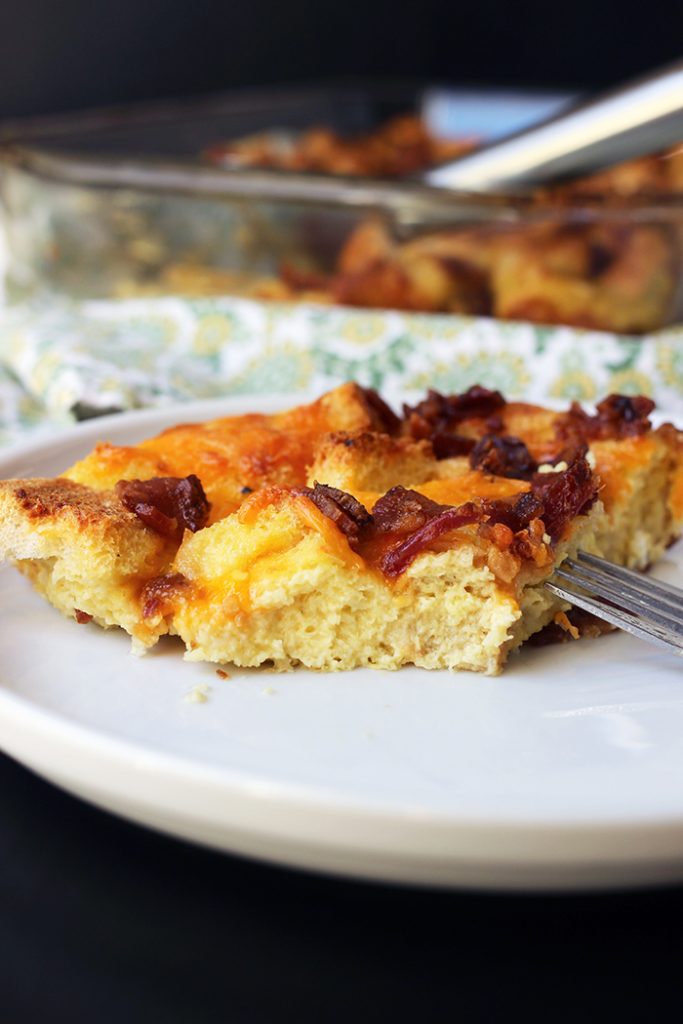 cut slice of egg bake on plate with fork