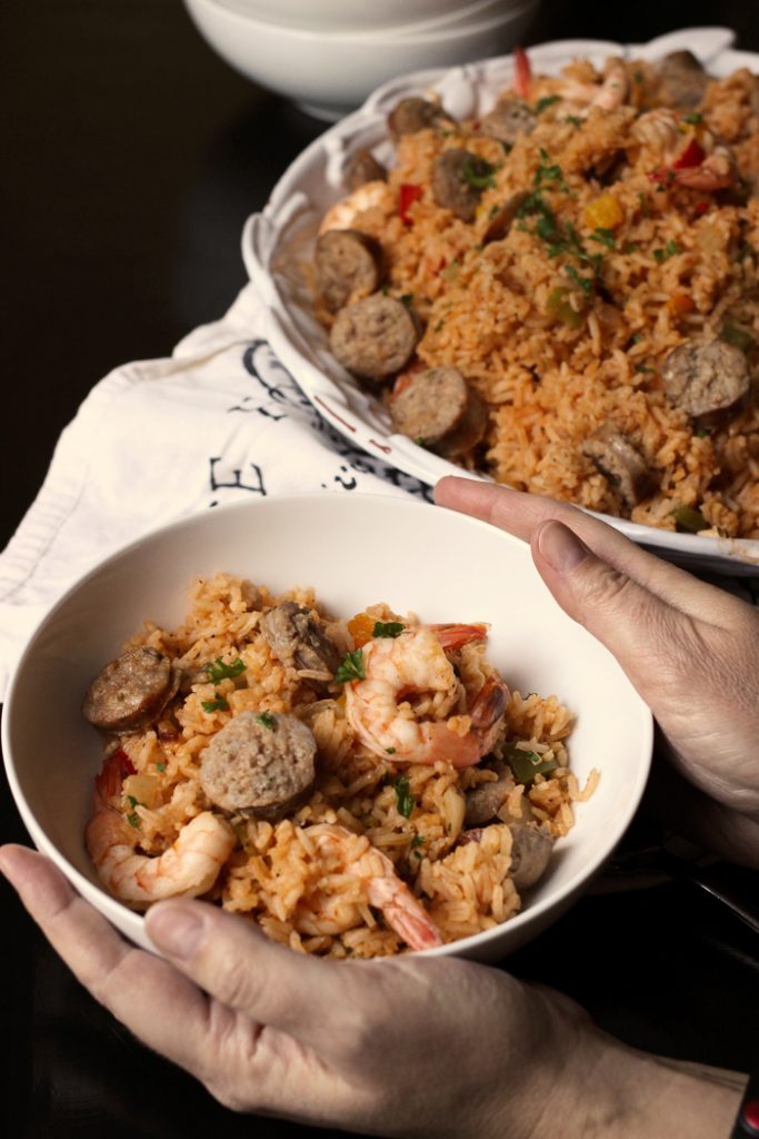 holding bowl of jambalaya