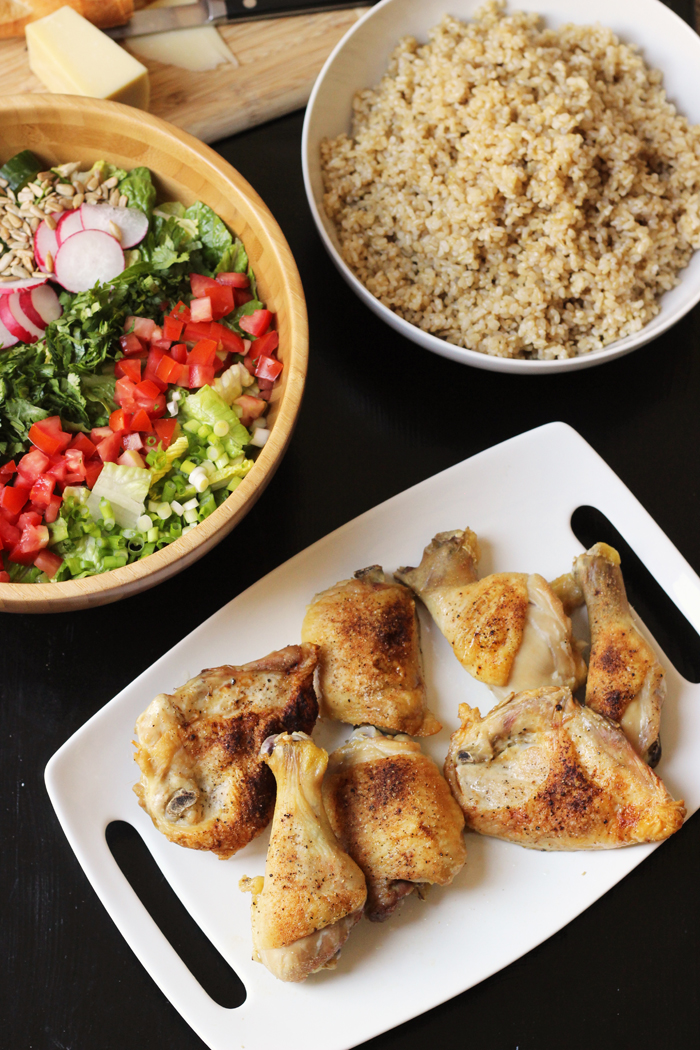 platter of baked chicken, salad, and bowl of rice