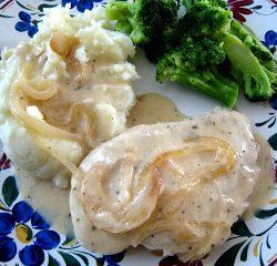 A plate of mashed potatoes and chicken