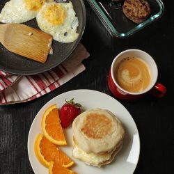 plate of breakfast sandwich and cup of coffee
