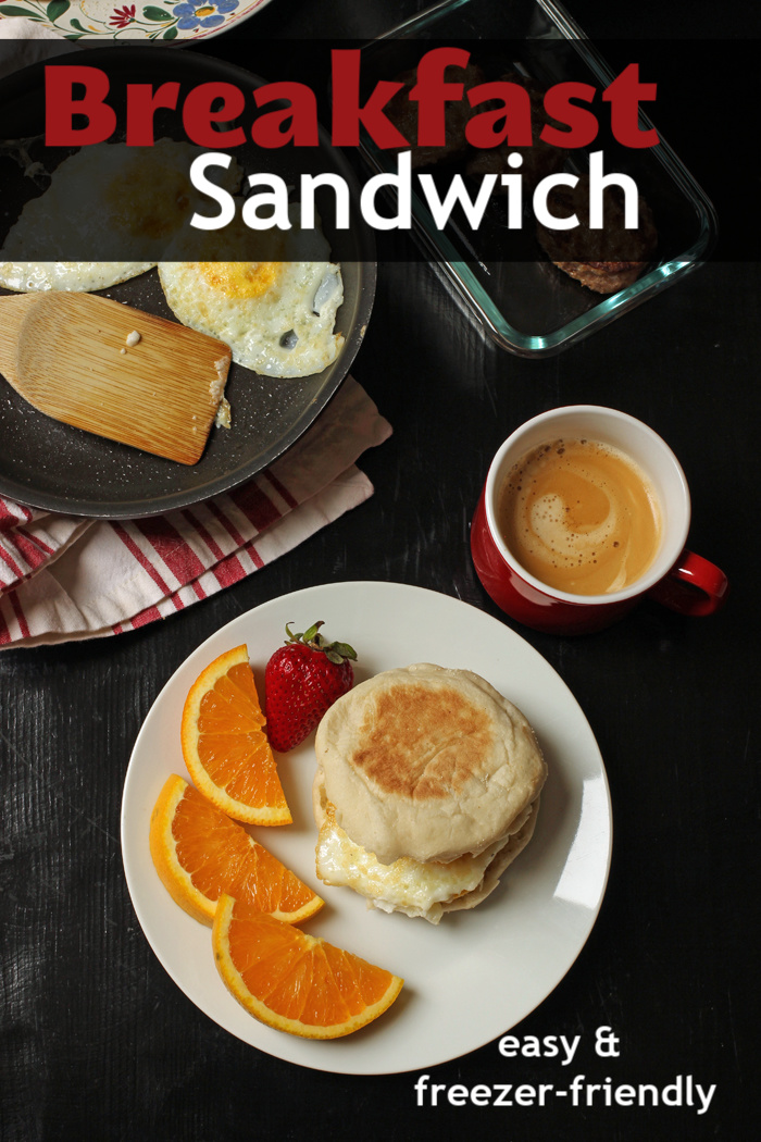 breakfast sandwich on plate with fruit and coffee