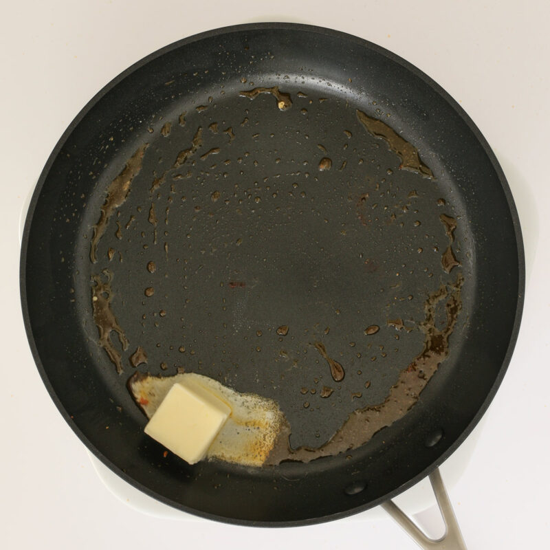 melting butter in the skillet of chicken drippings.