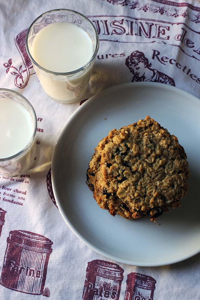 plate of cookies cups of milk on tea towel