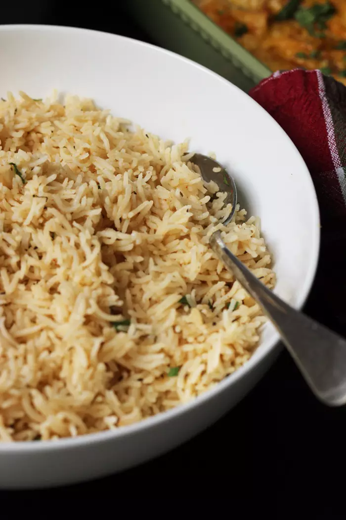 spoon resting in a bowl of rice