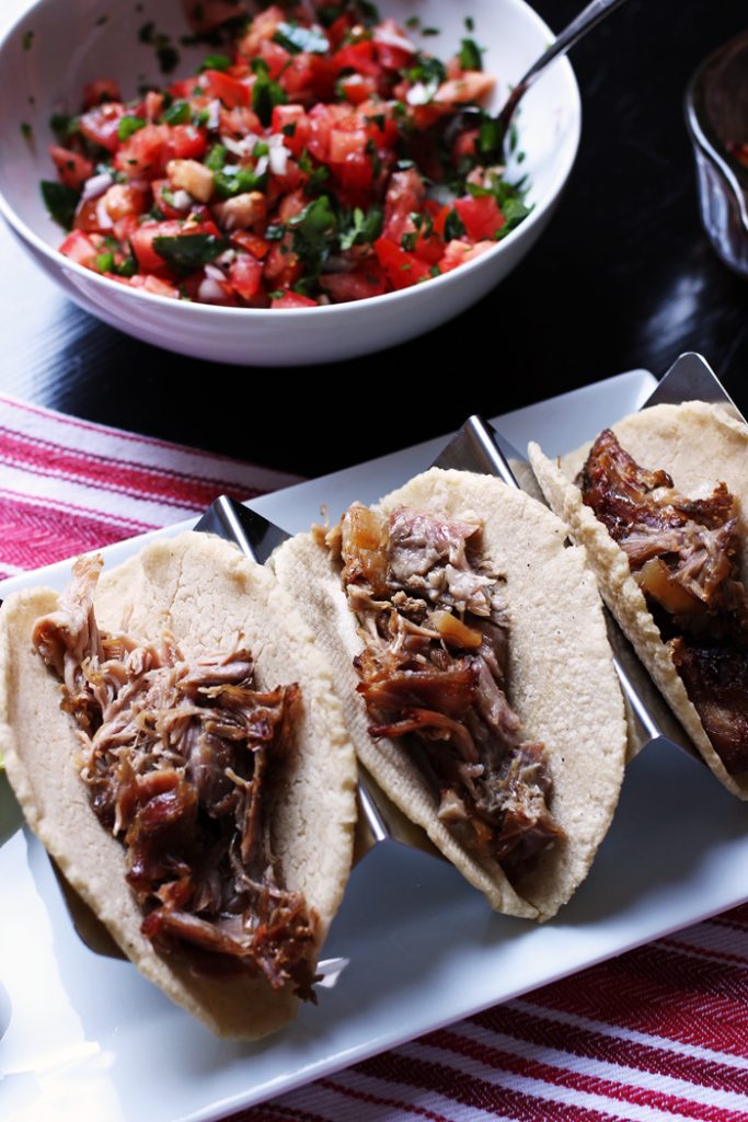 taco holder with three carnitas tacos