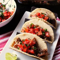 A trio of tacos on taco holder