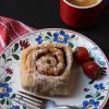 cinnamon roll and strawberries on a plate