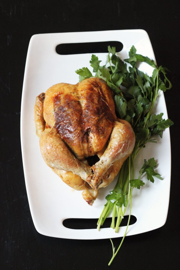A roast chicken on a platter