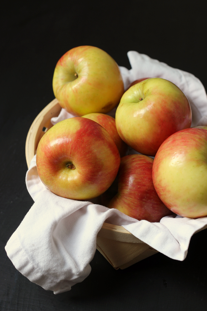 basket of apples lined with white napkin