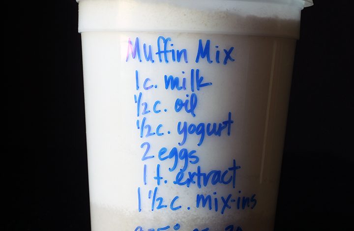 muffins in plastic tub with blue writing