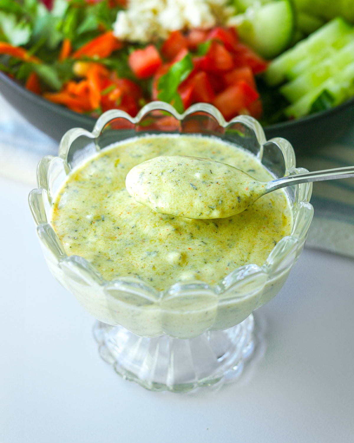 small glass dish with greek yogurt salad dressing.