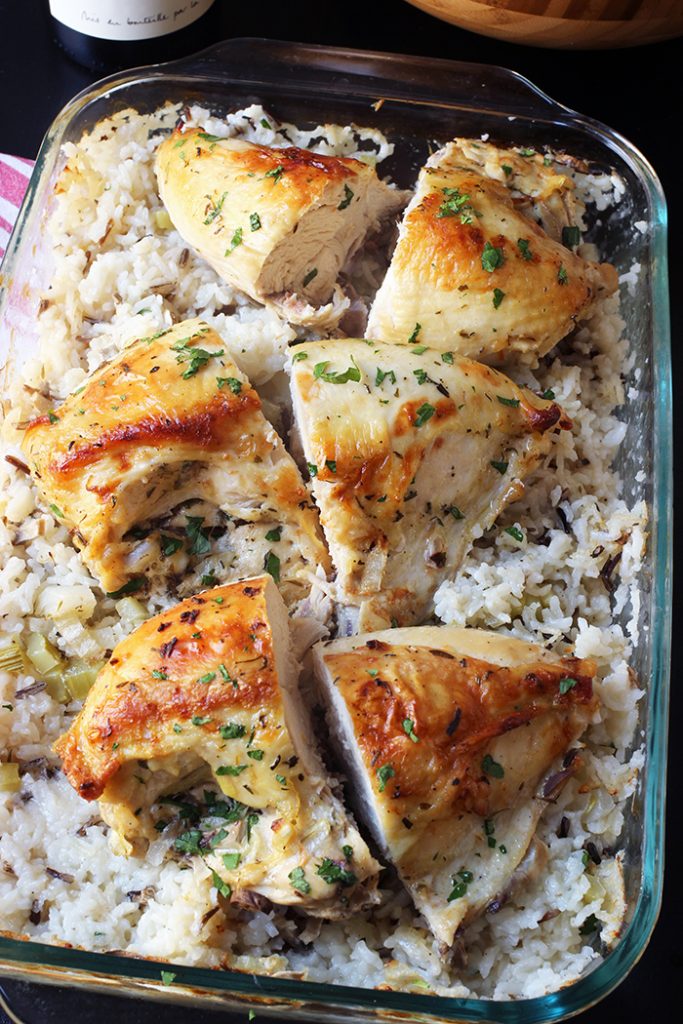 chicken on bed of rice in baking dish