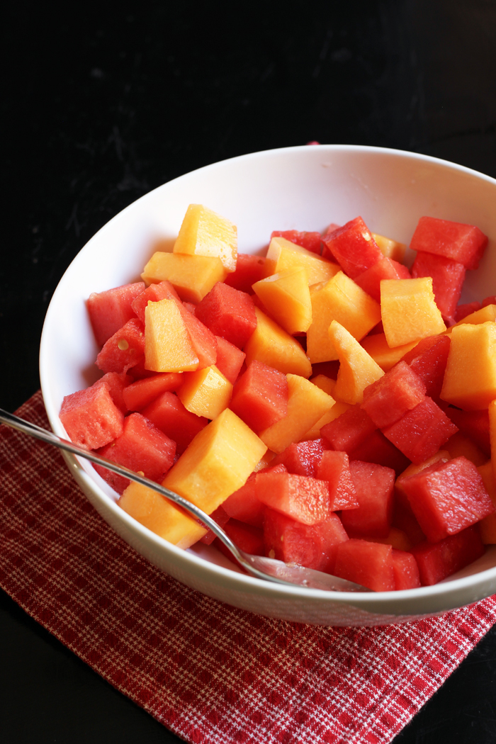 cutting cantaloupe for fruit tray