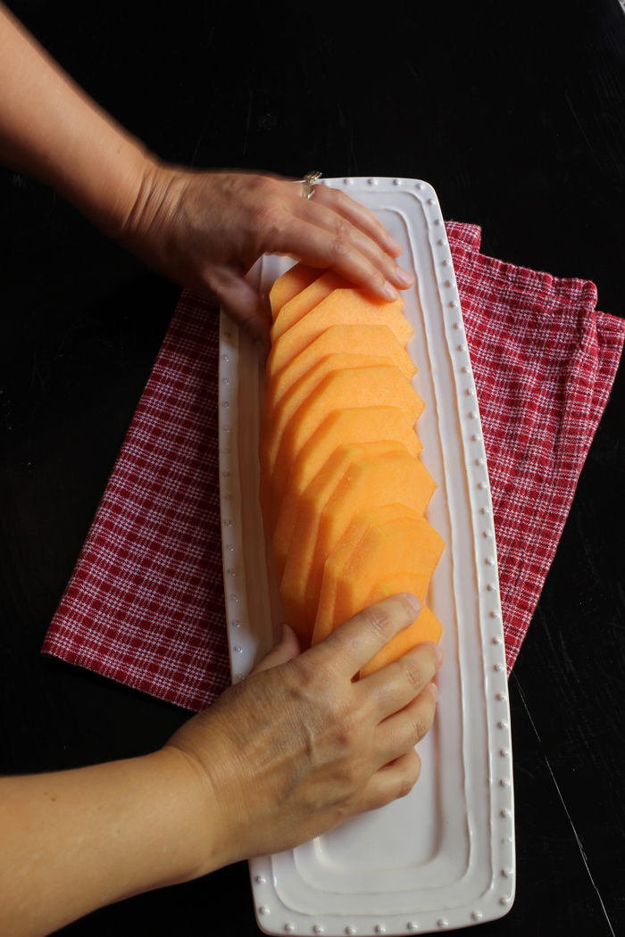 cutting cantaloupe for fruit tray