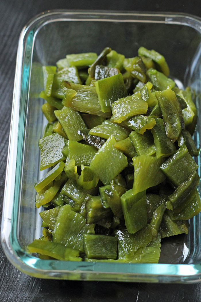 roasted poblano chiles in a glass dish to freeze for later