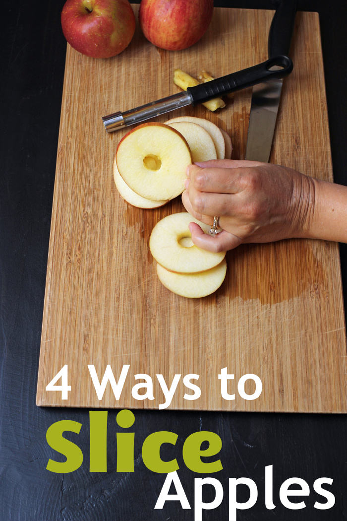 An apple sitting on top of a wooden cutting board