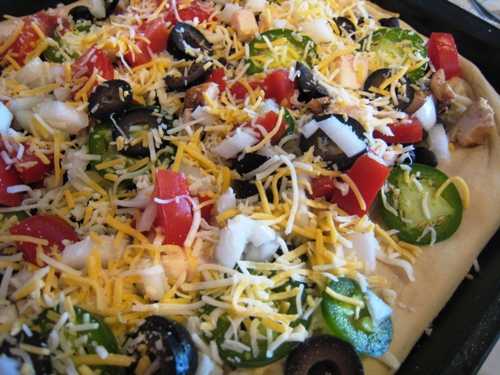 A pizza covered in cheese and toppings