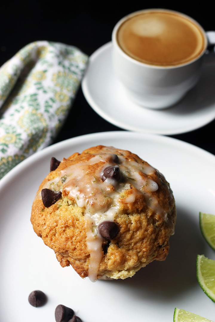 chocolate chip muffin on plate with cup of espresso