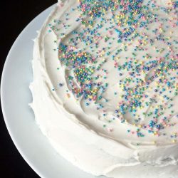 sprinkled white layer cake on white platter