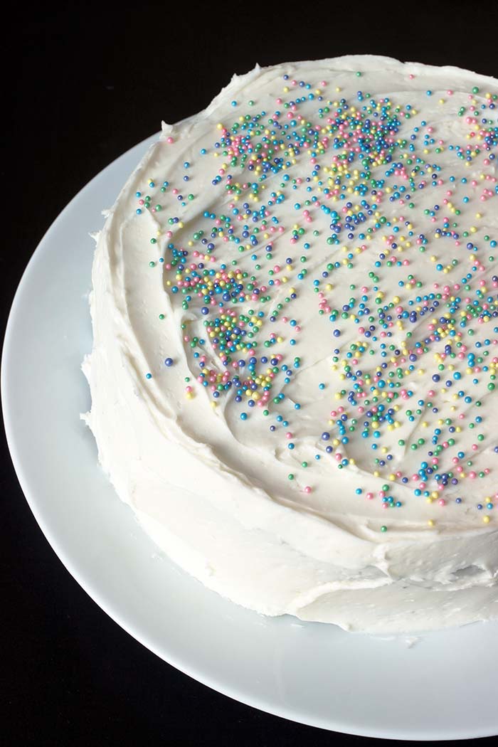 sprinkled white layer cake on white platter