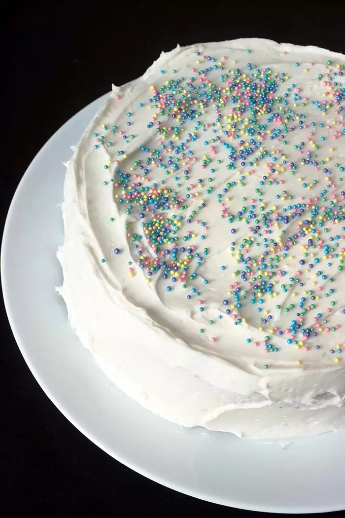 sprinkled white layer cake on white platter