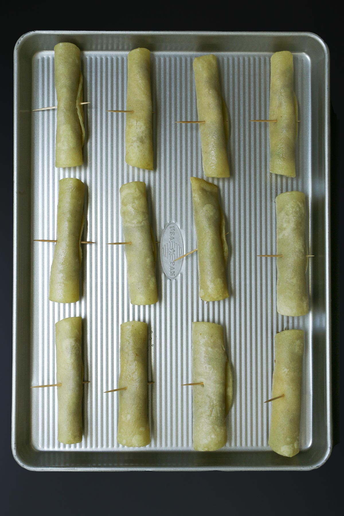 rolled taquitos on a tray.