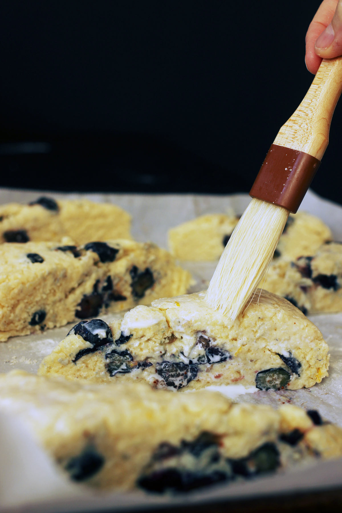 brushing milk on scones