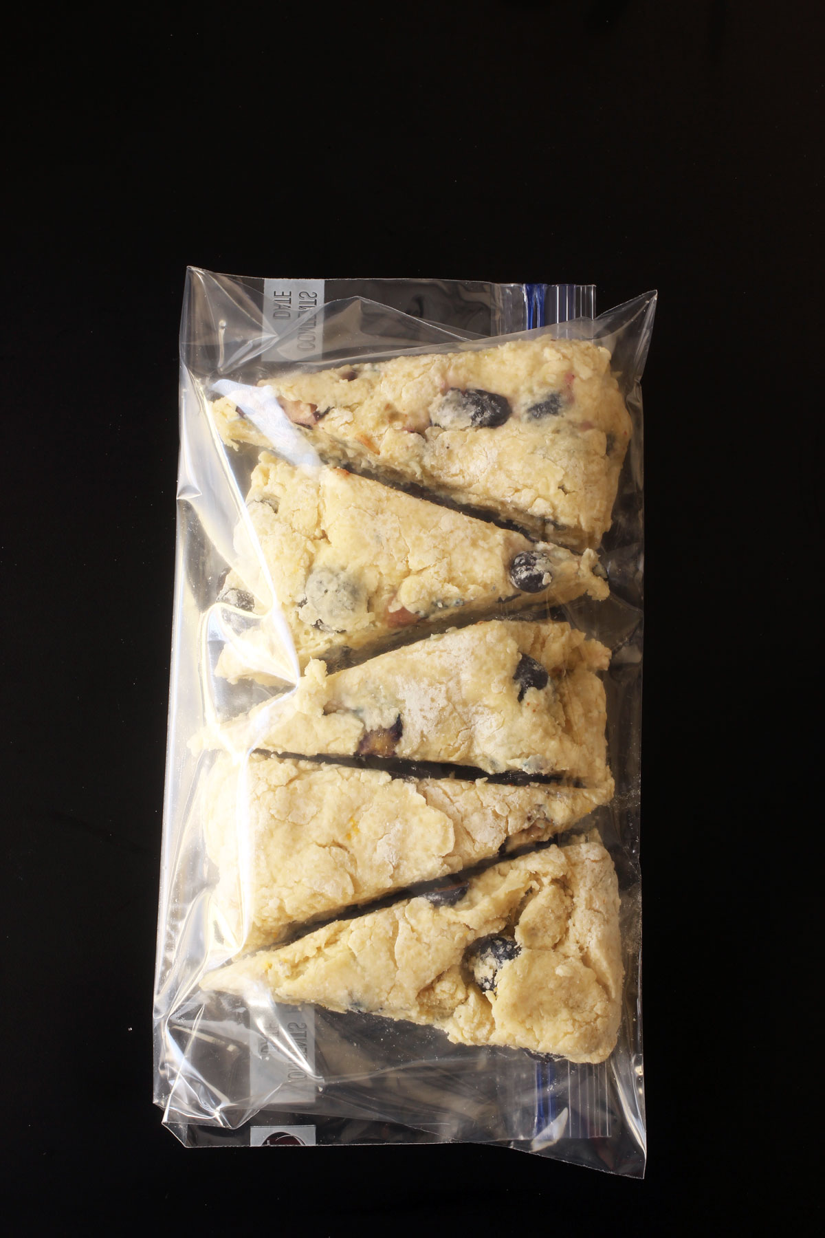 frozen lemon blueberry scones in a ziptop freezer bag ready to be baked.