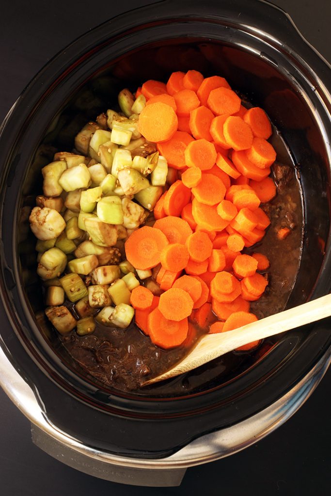 adding eggplant and carrots to stew