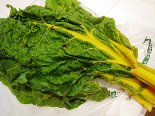 A table topped with fresh chard