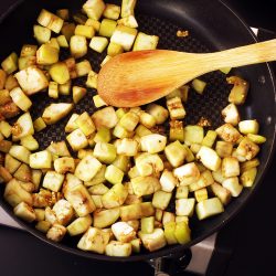 sauteeing eggplant cubes in skillet