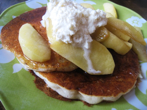 apples and whipped butter on stack of pancakes