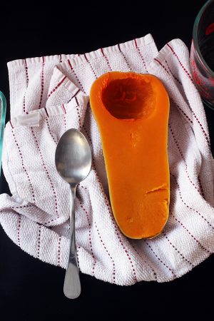 cooked squash and spoon on towel